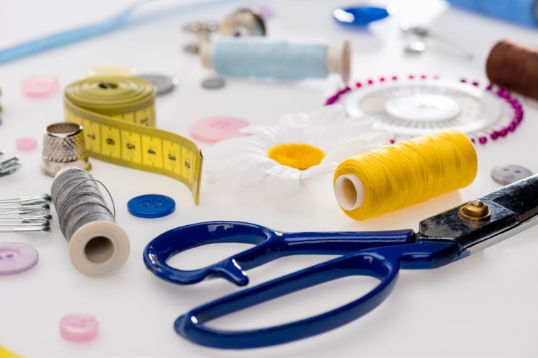 Basic essential arts and crafts tools and supplies on a white backdrop