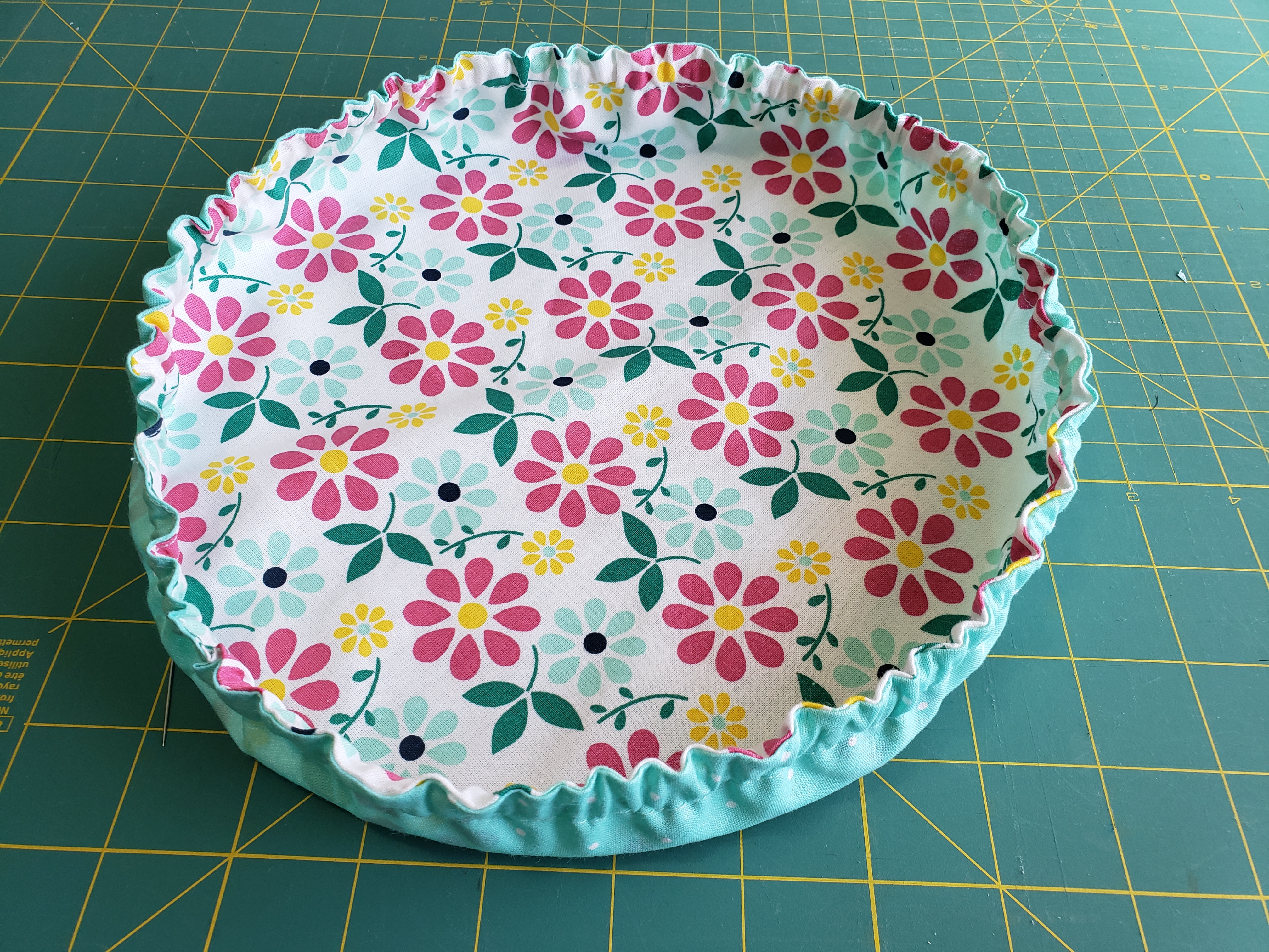 completed reversible mixing bowl cover lying flat on green cutting mat