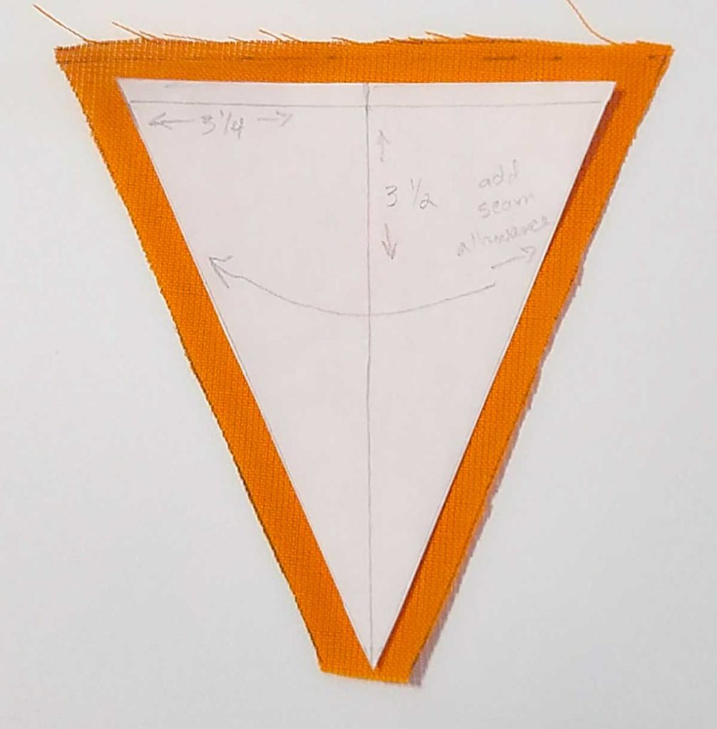place fabric carrot pattern over the fabric and cut out, making sure to leave enough space for seam allowance