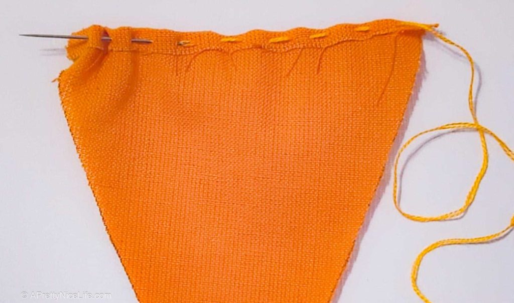 Shows how to sew the running stitch for later gathering up the top of the cute fabric carrot you're sewing