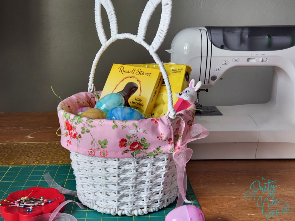 A cute Easter basket with a handmade diy fabric basket liner and a sewing machine behind it