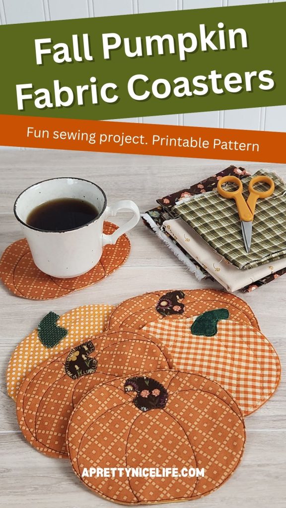 Six quilted fabric pumpkin coasters on a wood table with a coffee cup resting on one. Fall fabric scraps and small scissors are visible in the background. Text reads: "Fall Pumpkin Fabric Coasters. Fun Sewing Project. Printable Pattern. Aprettynicelife.com"