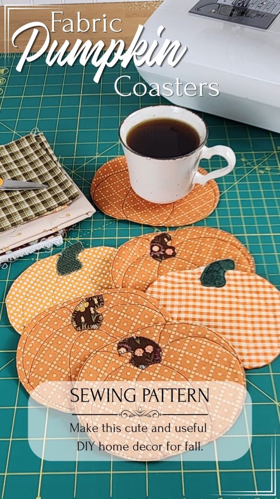 Six quilted fabric pumpkin coasters on a green self-healing cutting mat with a coffee cup, fall fabric scraps, and a sewing machine visible in the corner. Text reads: "Fabric Pumpkin Coasters Sewing Pattern. Make This Cute and Useful DIY Home Decor for Fall"