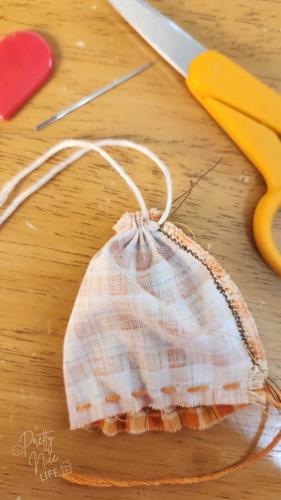 photo shows the gathered bottom edge of the still-inside-out tube of fabric.